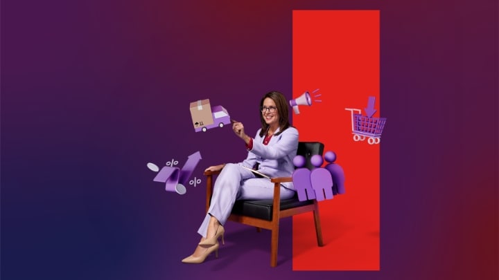 Picture of a woman standing inside a server room while using a tablet.